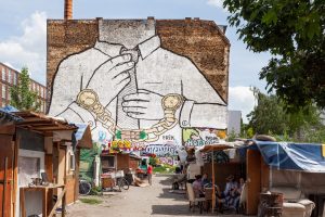 Inside the Cuvrybrache in densely populated by homelesss people, refugees and shacks